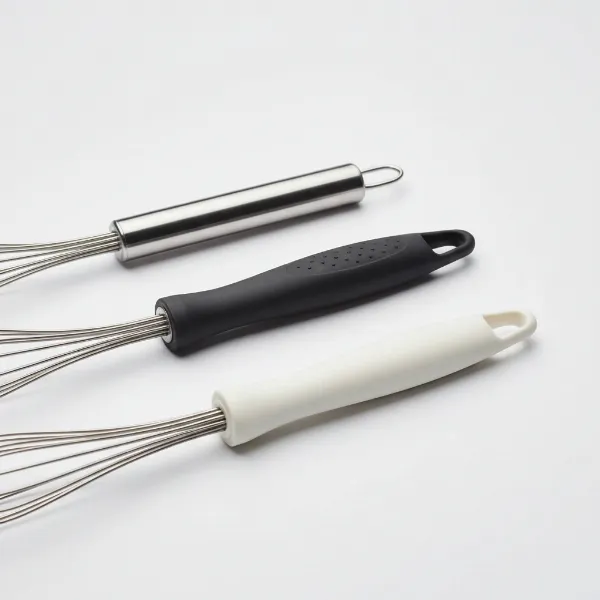 A comparative display of whisk handles made from stainless steel, silicone, and plastic, emphasizing the importance of material and grip in selection.